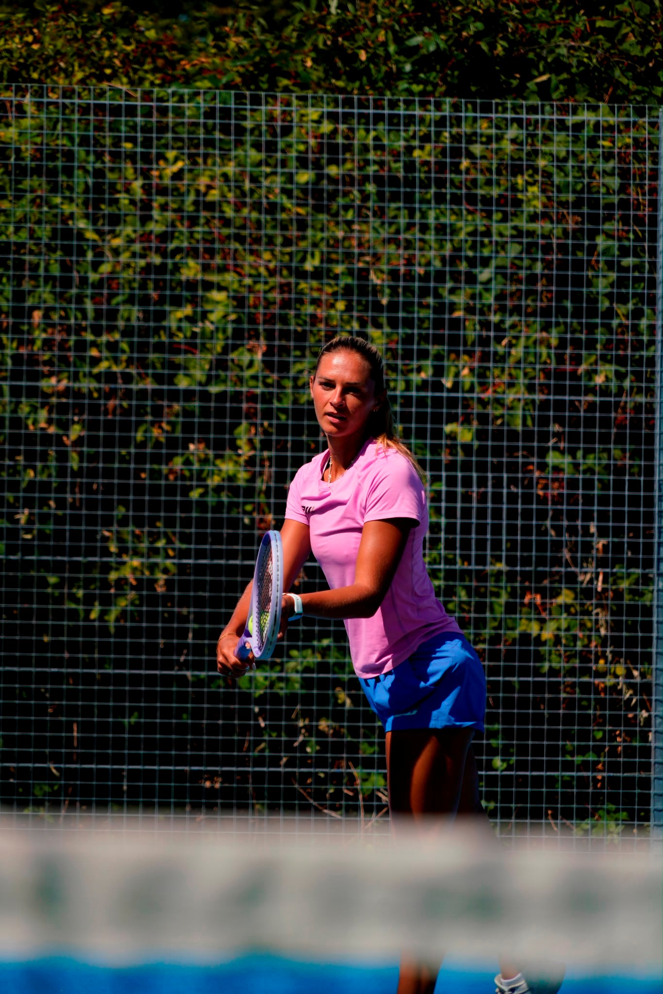 Taz coaching and demonstrating on an outdoor tennis court