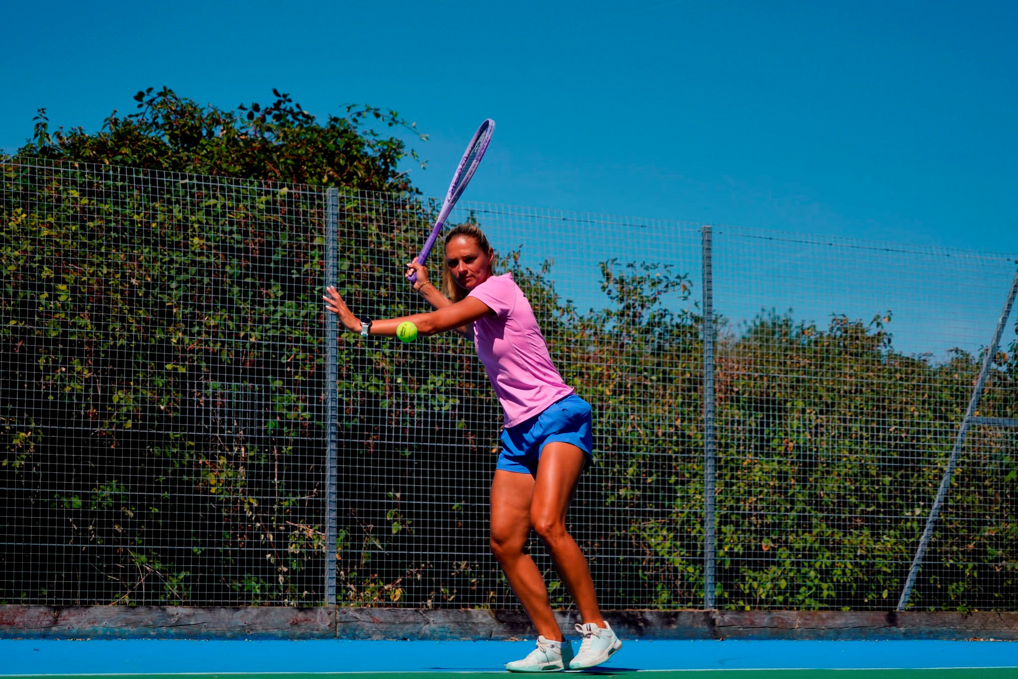 Taz demonstrating a tennis stroke during outdoor training