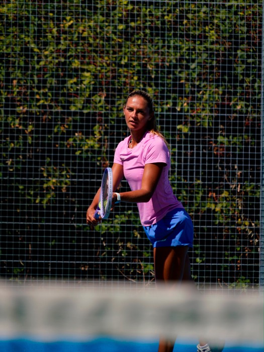 Taz preparing to play on an outdoor tennis court