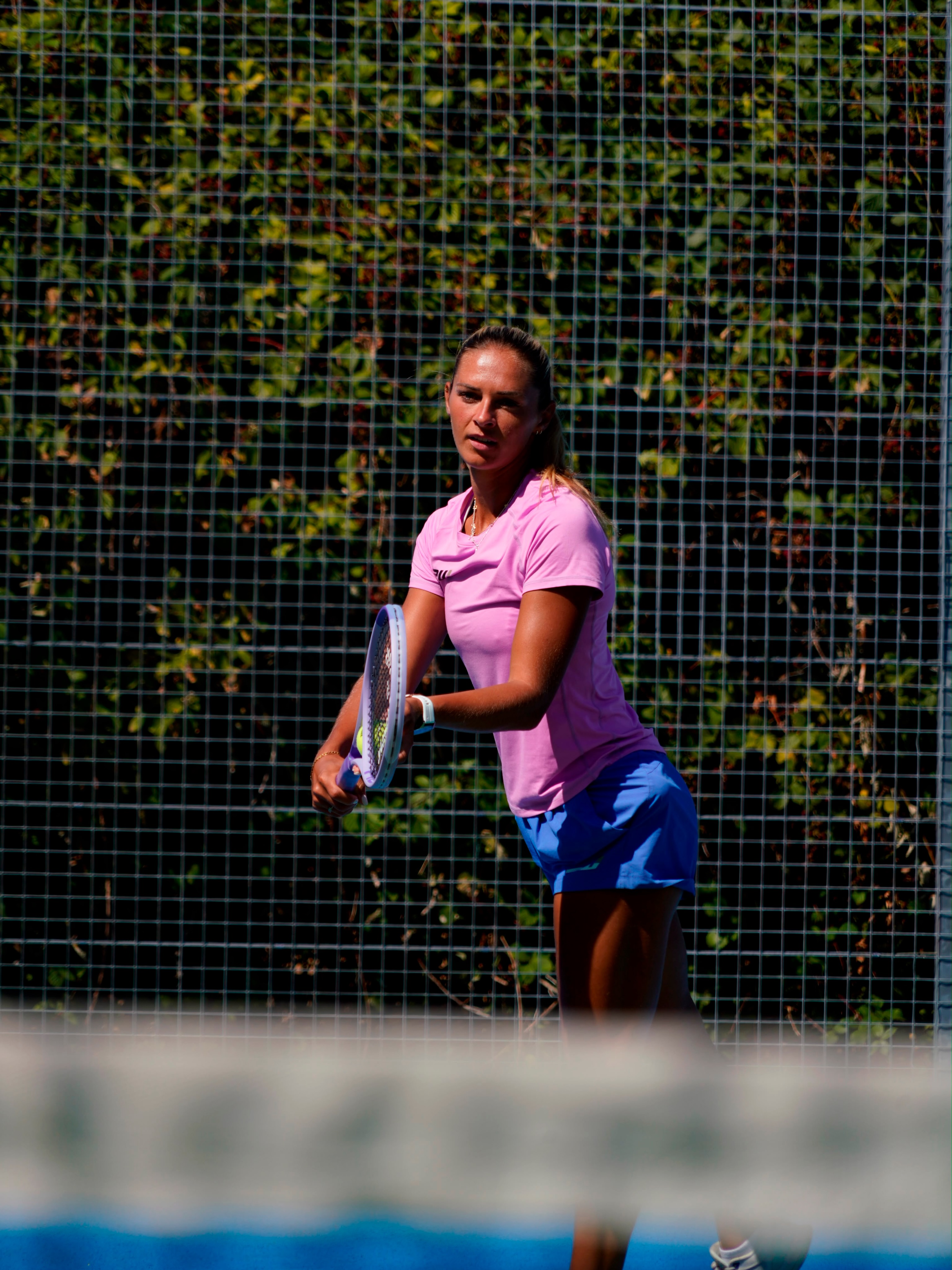 Taz preparing to play on an outdoor tennis court
