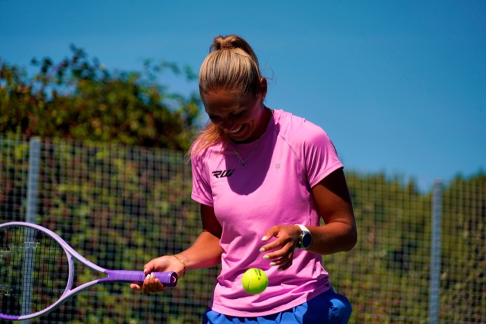 Taz smiling during an outdoor tennis session