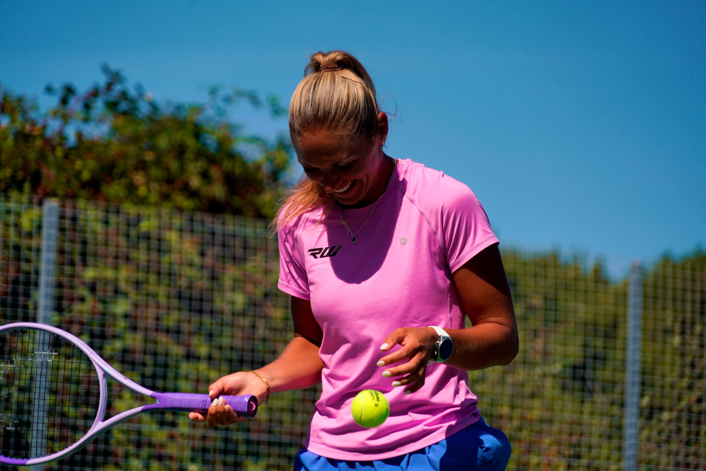 Taz smiling during an outdoor tennis session